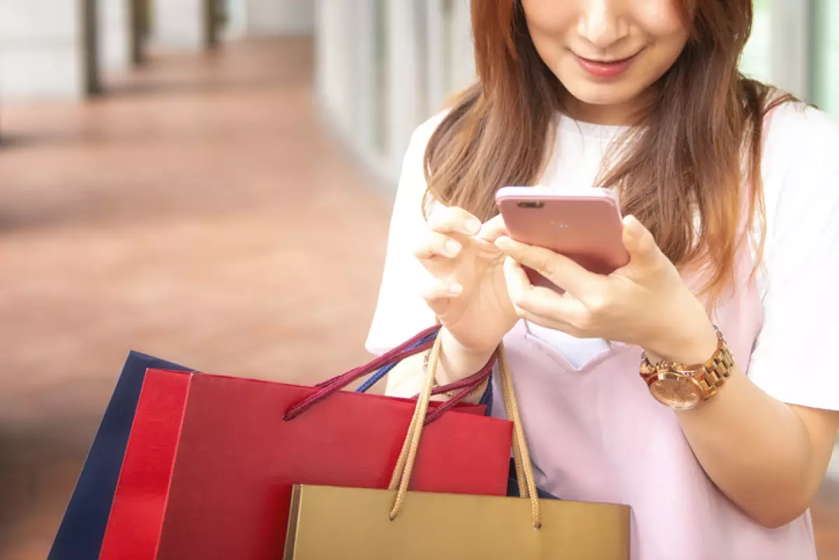Young Woman Use Of Mobile Phone In Shopping Mall