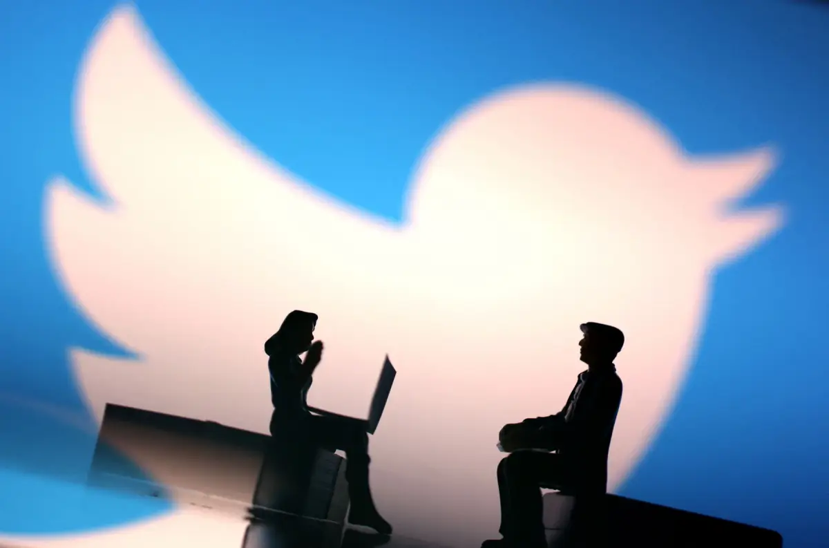 Illustration shows small figurines and Twitter logo