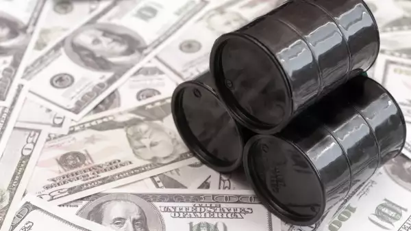 Barrels of oil against the background of American dollars