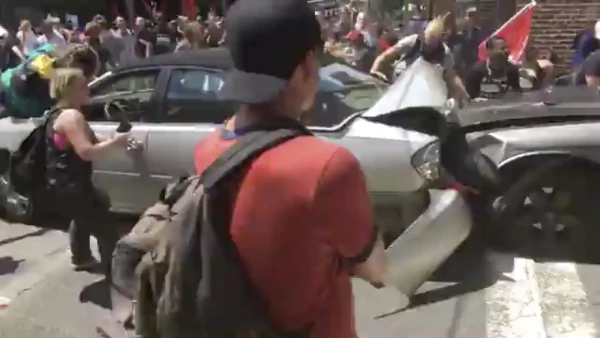 A vehicle plows into the crowd gathered on a street in Charlottesville