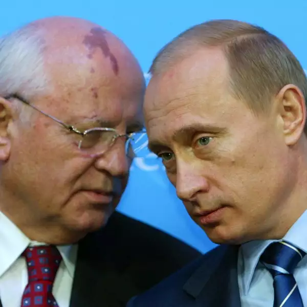 FILE PHOTO: Russian President Putin listens to former President of the Soviet Union Gorbachev during news conference in Schleswig