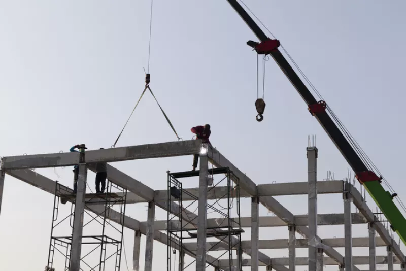 precast concrete beam installed at construction site by mobile crane