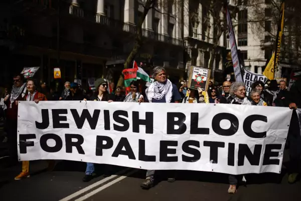 Activistas y partidarios propalestinos sostienen una pancarta mientras marchan durante una protesta en el centro de Londres el 30 de marzo de 2024, pidiendo un alto el fuego en el conflicto entre Israel y Hamas.