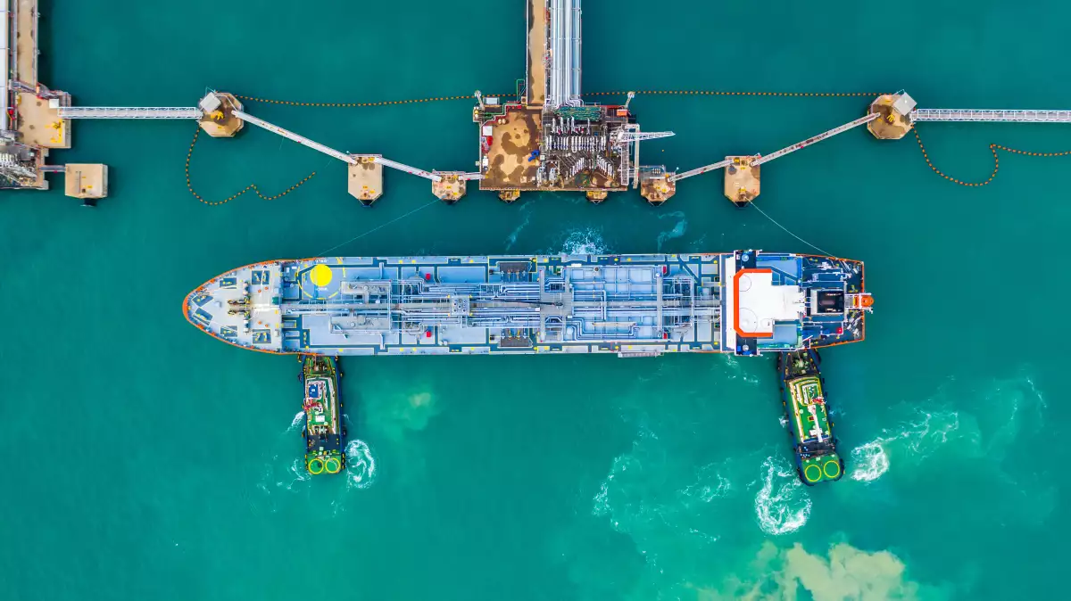 Fuel tanker ship loading in port view from above, Tanker ship logistic import export business and transportation, Aerial view.