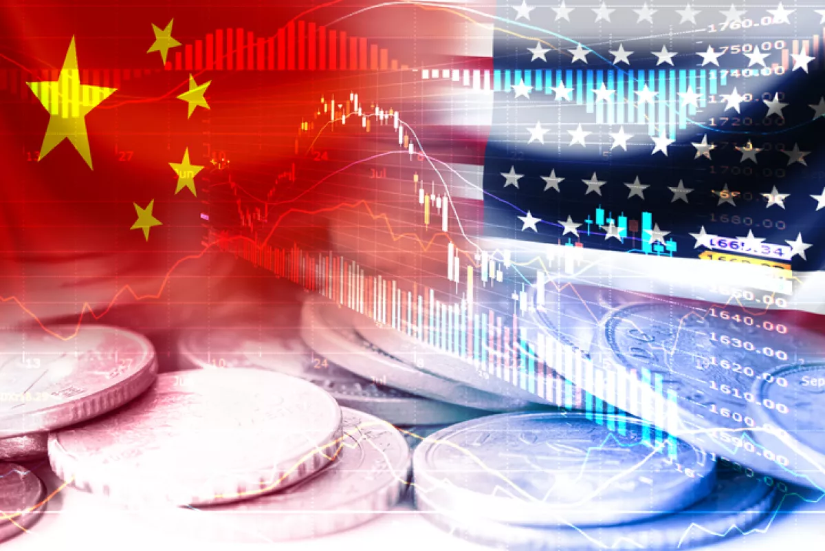 USA and China flag on coins and stock market chart .It is symbol of economic tariffs trade war and tax barrier between United States of America and China.