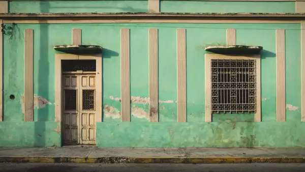 Facade of typical Mexican green colonial building in Merida, Yucatan, Mexico