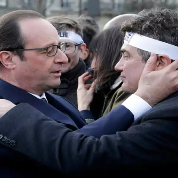 El mandatario consuela al columnista de Charlie Hebdo Patrick Pelloux durante la marcha en la que participaron familiares y parientes de las víctimas. 