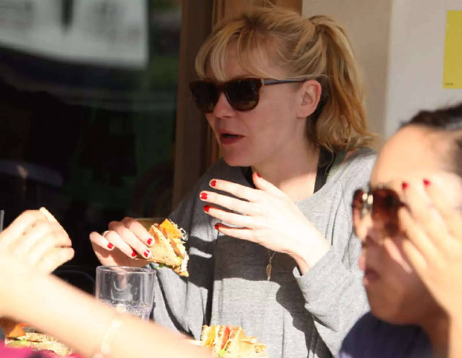 La bella actriz Kirsten Dunst se dejó envolver por las redes de un rico sandwich, mientras platicaba muy agusto con una amiga.