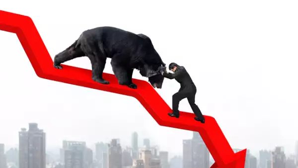 Businessman against bear on arrow downward trend line with citys