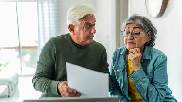 Senior couple using computer and doing home finances at home