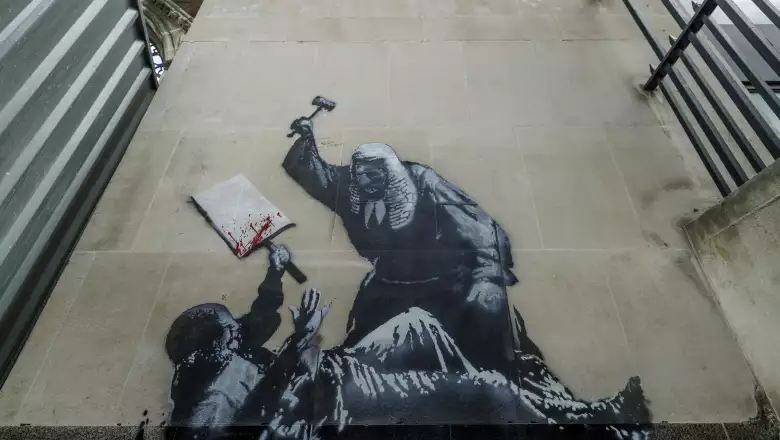 Latest Banksy Mural Covered And Guarded By Security At The Royal Courts Of Justice