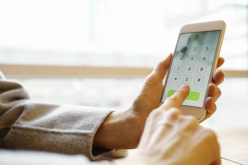 photo of female hands dialing a smartphone