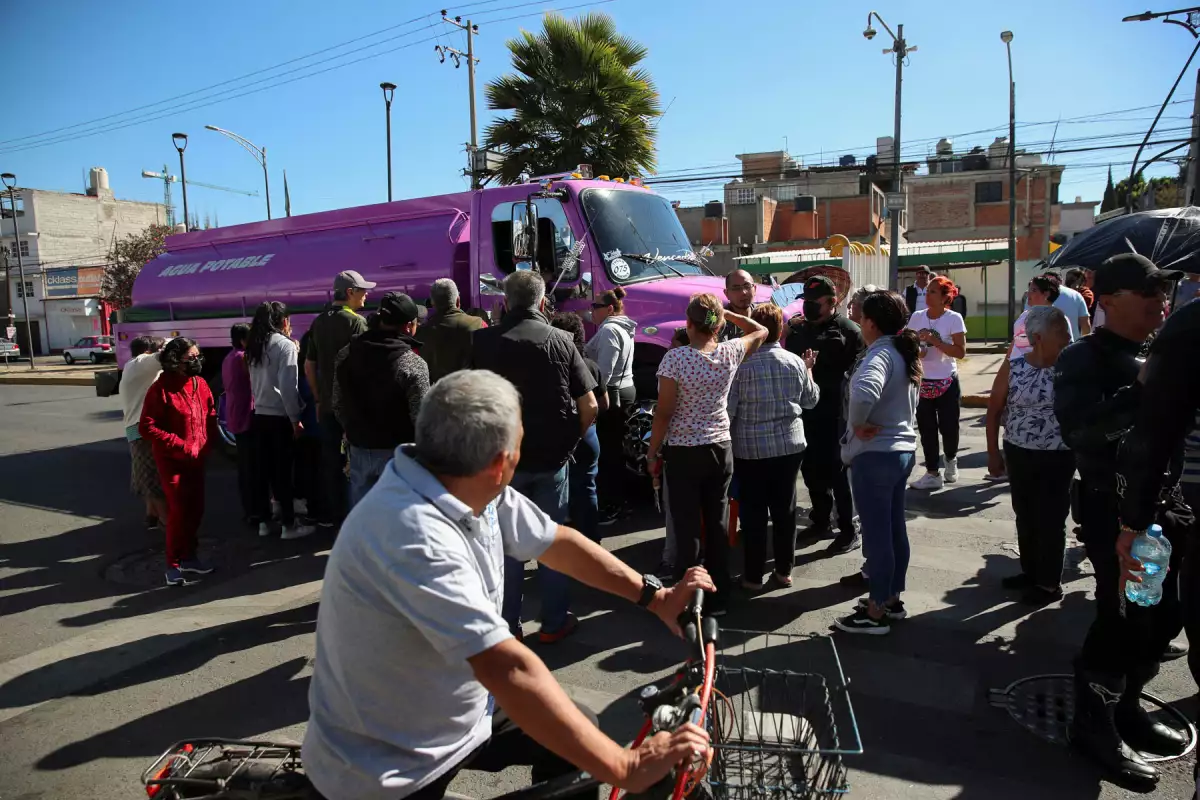 Residents gather near a water tanker truck in Mexico City