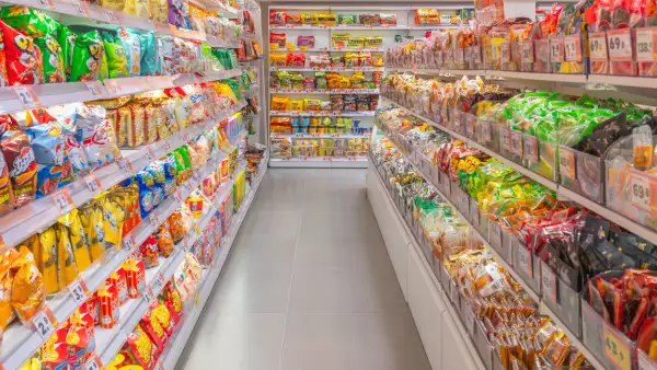 Well-stocked snack aisle in a bright modern supermarket