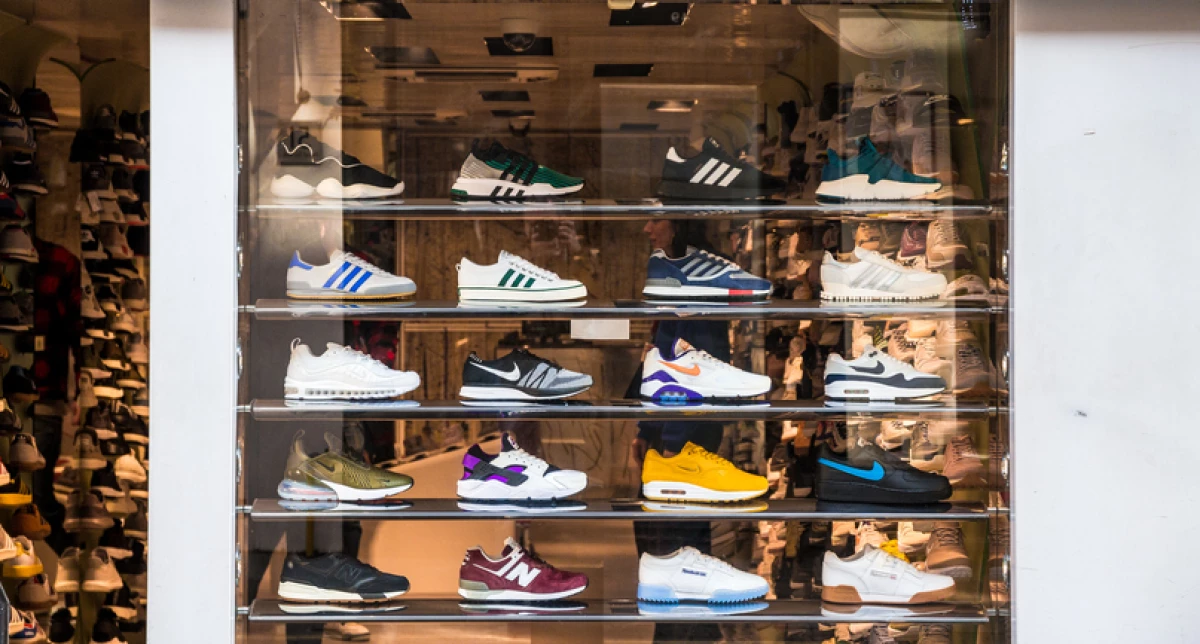 Fashionable sneakers on display in shop window, London, UK
