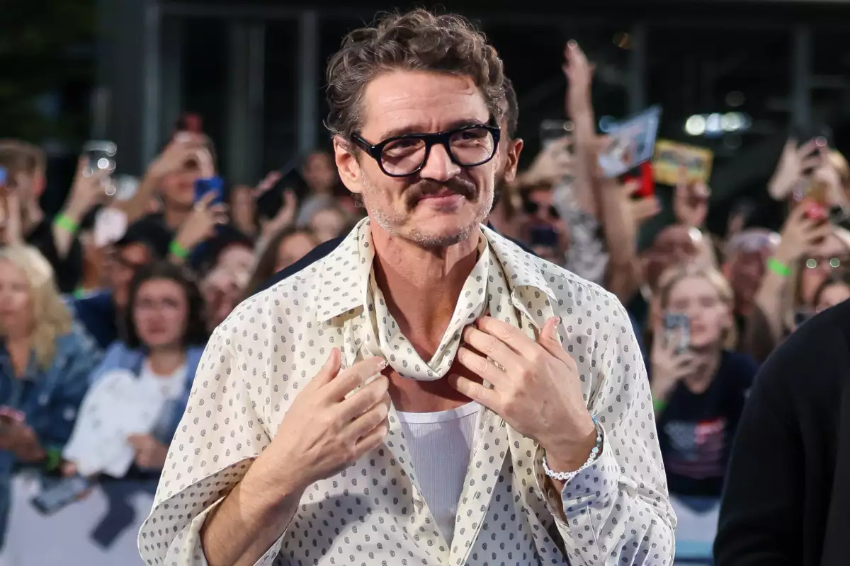 Foto de Pedro Pascal en la premier de 'Fantastic Four' en Berlín, con una camisa de transparencias y camiseta blanca de fondo.