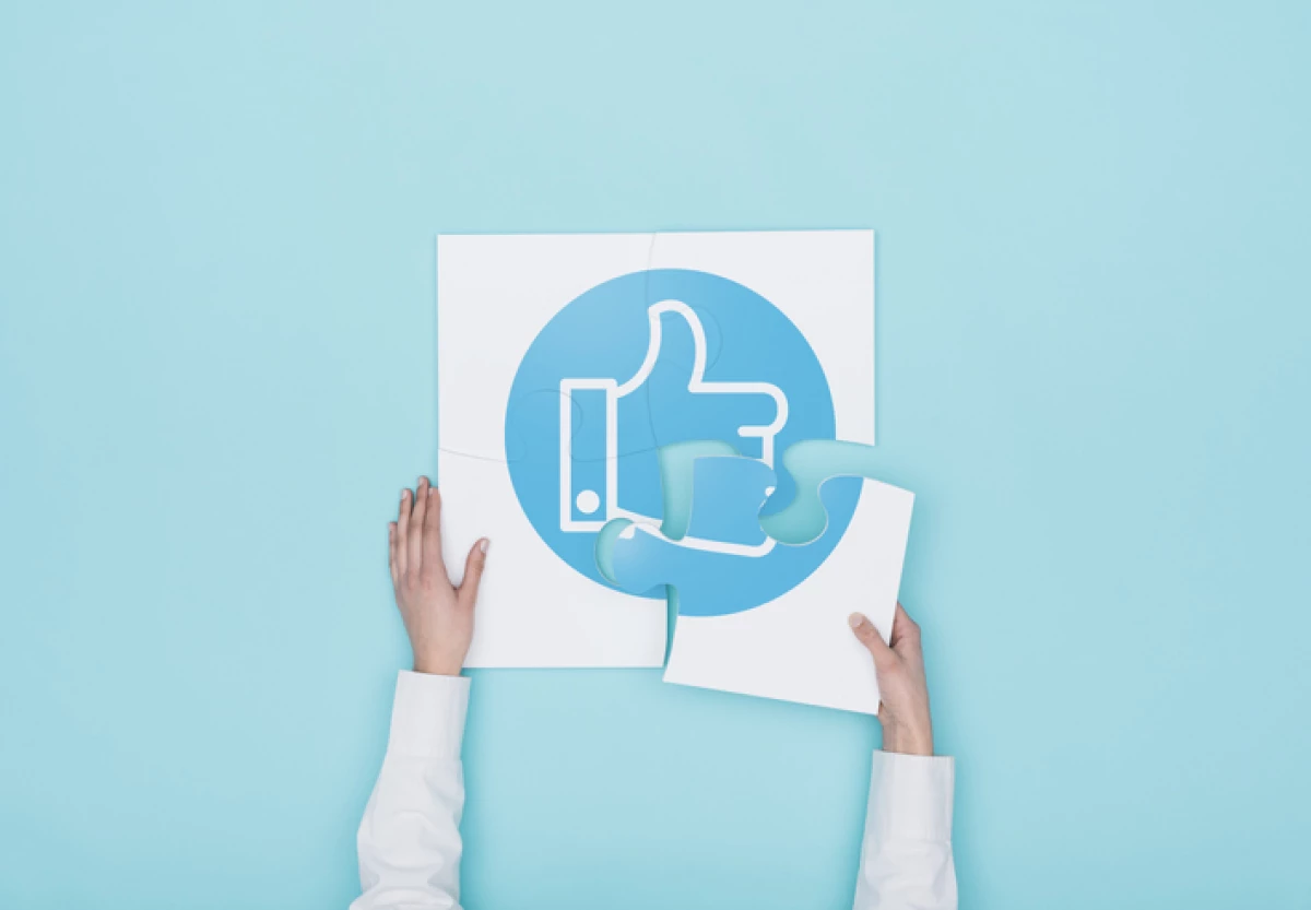 Woman completing a puzzle with thumbs up icon