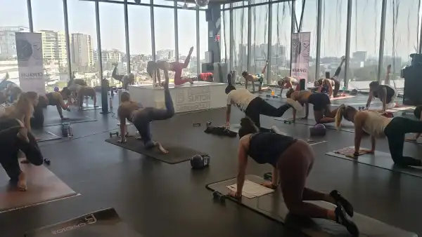 Gente haciendo ejercicio en un salon 
