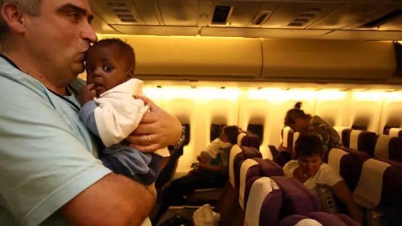 Padre abraza nino haitiano