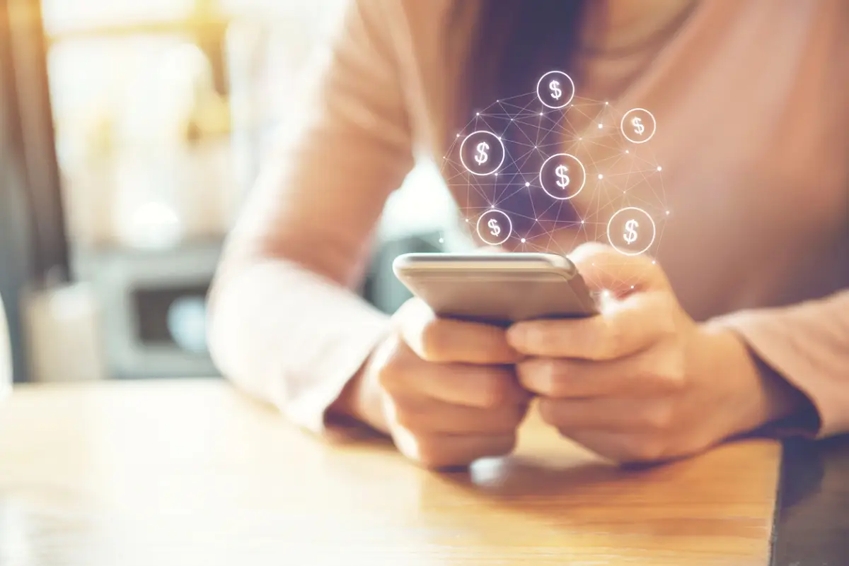 Female Hand using mobile smartphone with dollar icon