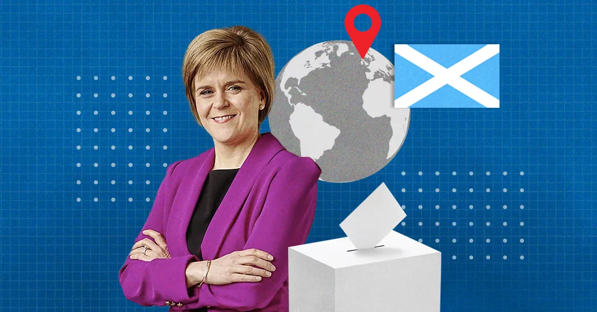 Nicola Strugeon, primera ministra de Escocia posa con los brazos cruzados y viste un saco morado. 