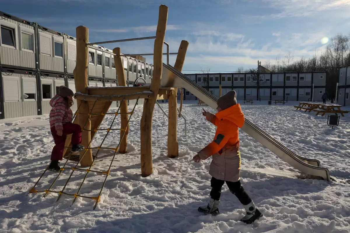 Children from Donbas region play near modular houses donated by the Polish government for Ukrainian internally displaced persons, amid Russia's attack on Ukraine, in Lviv, Ukraine February 9, 2023. REUTERS/Roman Baluk