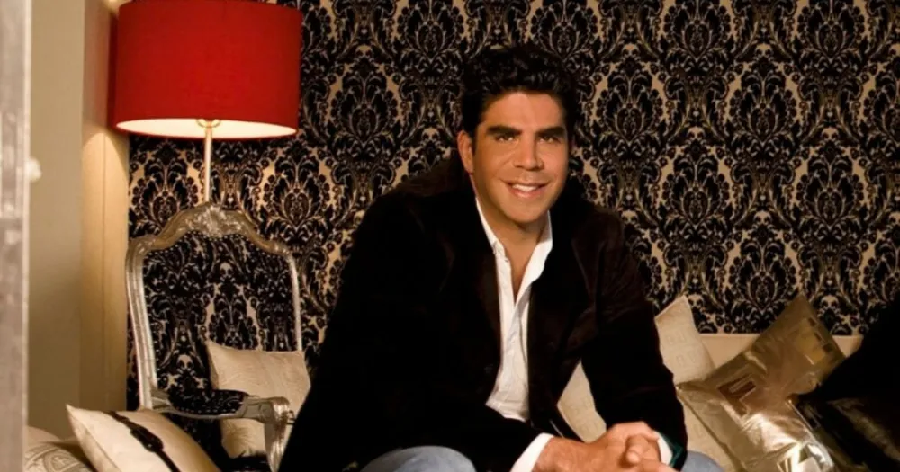 Jorge Kahwagi sentado en una sala con las manos cruzadas y sonriente. El empresario y exboxeador murió a los 58 años. 