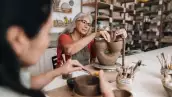 Senior woman making a craft product on a ceramics workshop