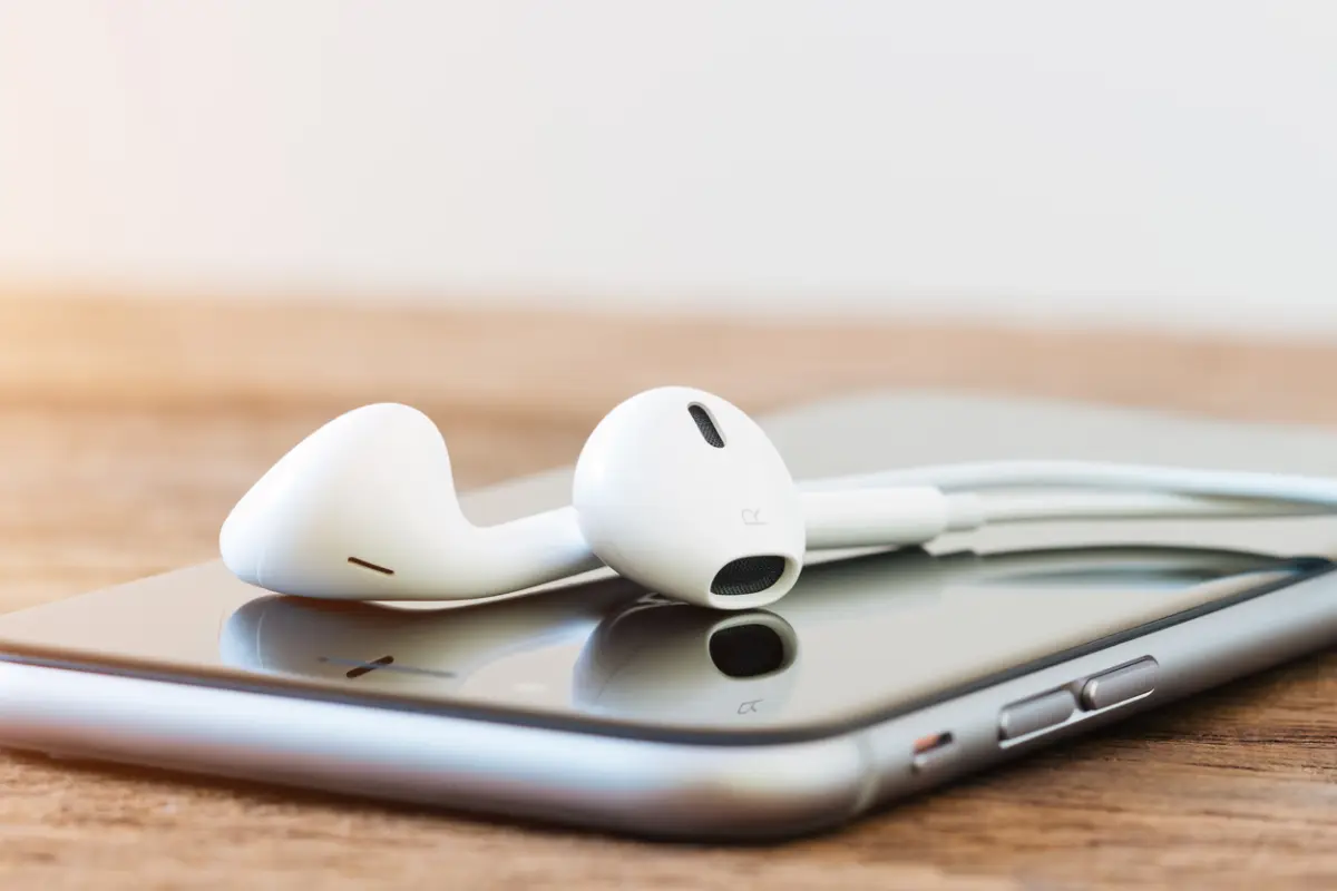 closeup iphone and earpods device on table