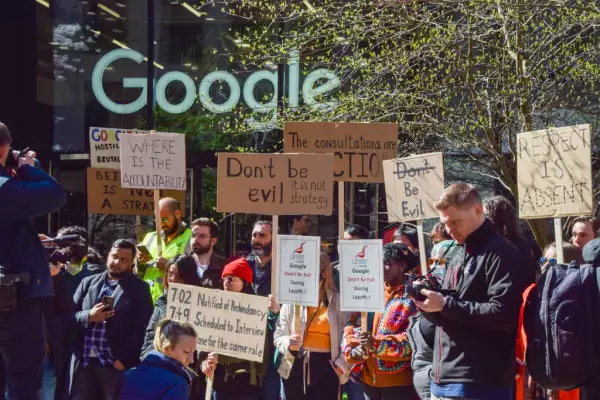 Protesters hold placards with 'Don't be evil' messages to