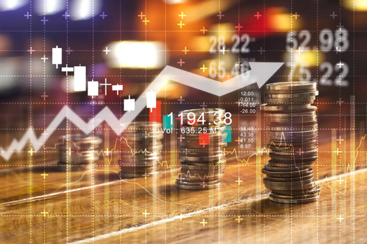 Finance and business concept. Investment graph and rows growth and of coins on table