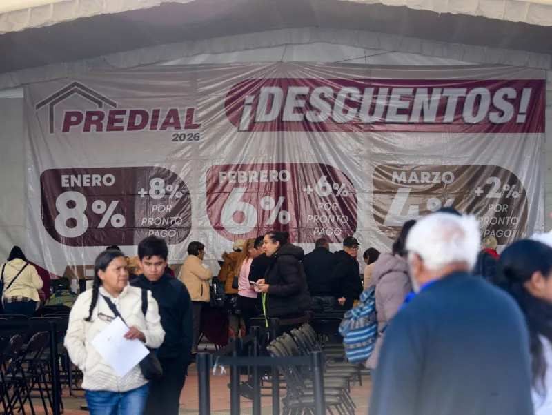 Personas esperan en fila para pagar su impuesto predial en Toluca, Estado de México.