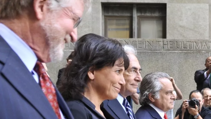Former IMF chief Dominique Strauss-Kahn (2nd R) and his wife Anne Sinclair (2nd L) leave the New York courthouse with lawyers William Taylor (L) and Benjamin Brafman on August 23, 2011 after a judge dropped charges against him of sexually assaulting hotel