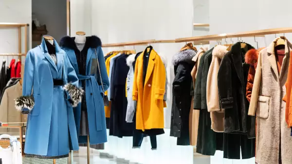 Female overcoat in modern clothing store