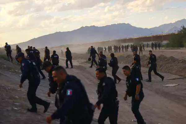 Migrants seeking asylum in the United States walk on the banks of the Rio Bravo River, the border between the U.S. and Mexico, in Ciudad Juarez