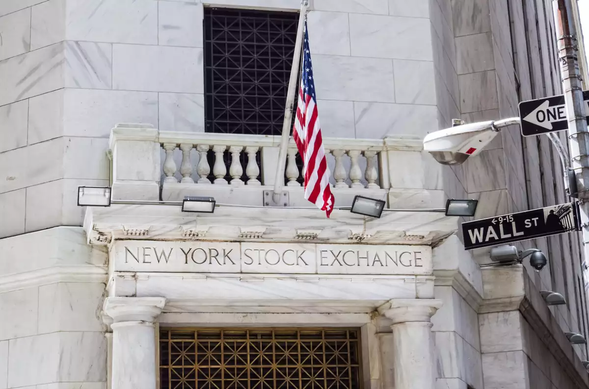 New York Stock Exchange with American flags and Wall street
