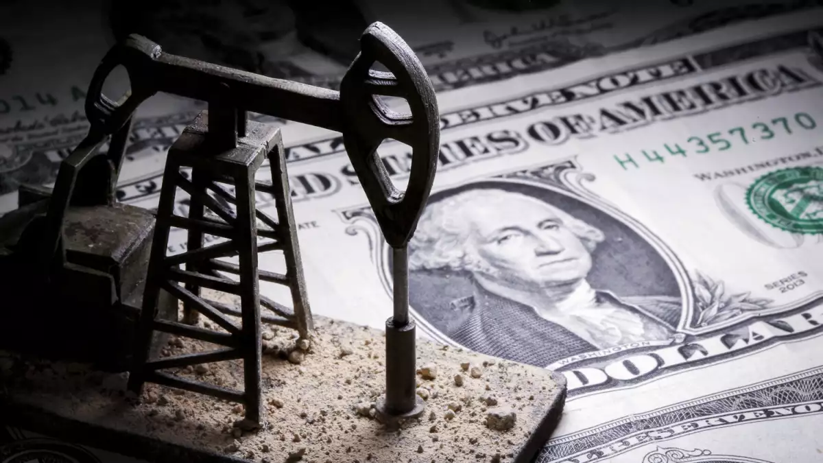 A 3D printed oil pump jack is placed on dollar banknotes in this illustration picture