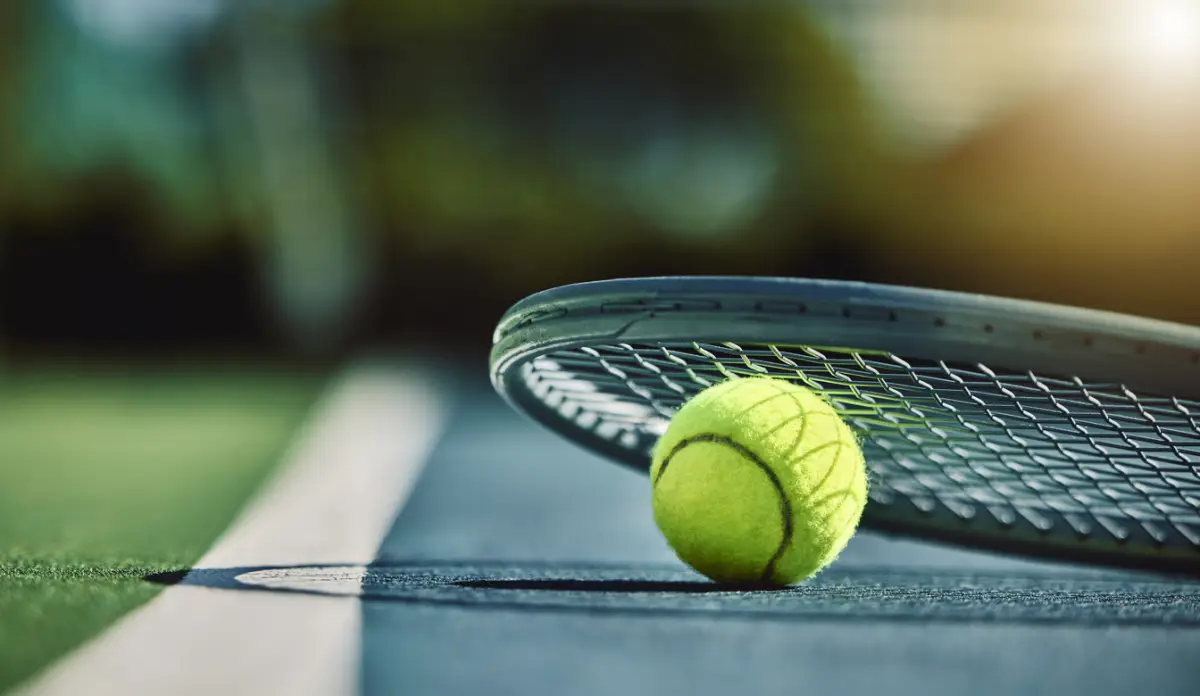 Tennis ball, racket and court ground with mockup space, blurred background or outdoor sunshine. 