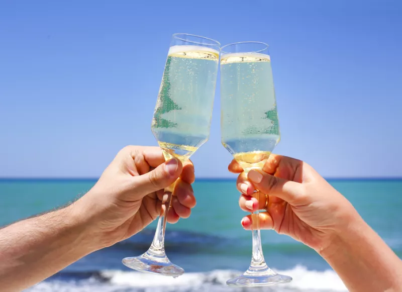 Two champagne glasses in man and woman hands