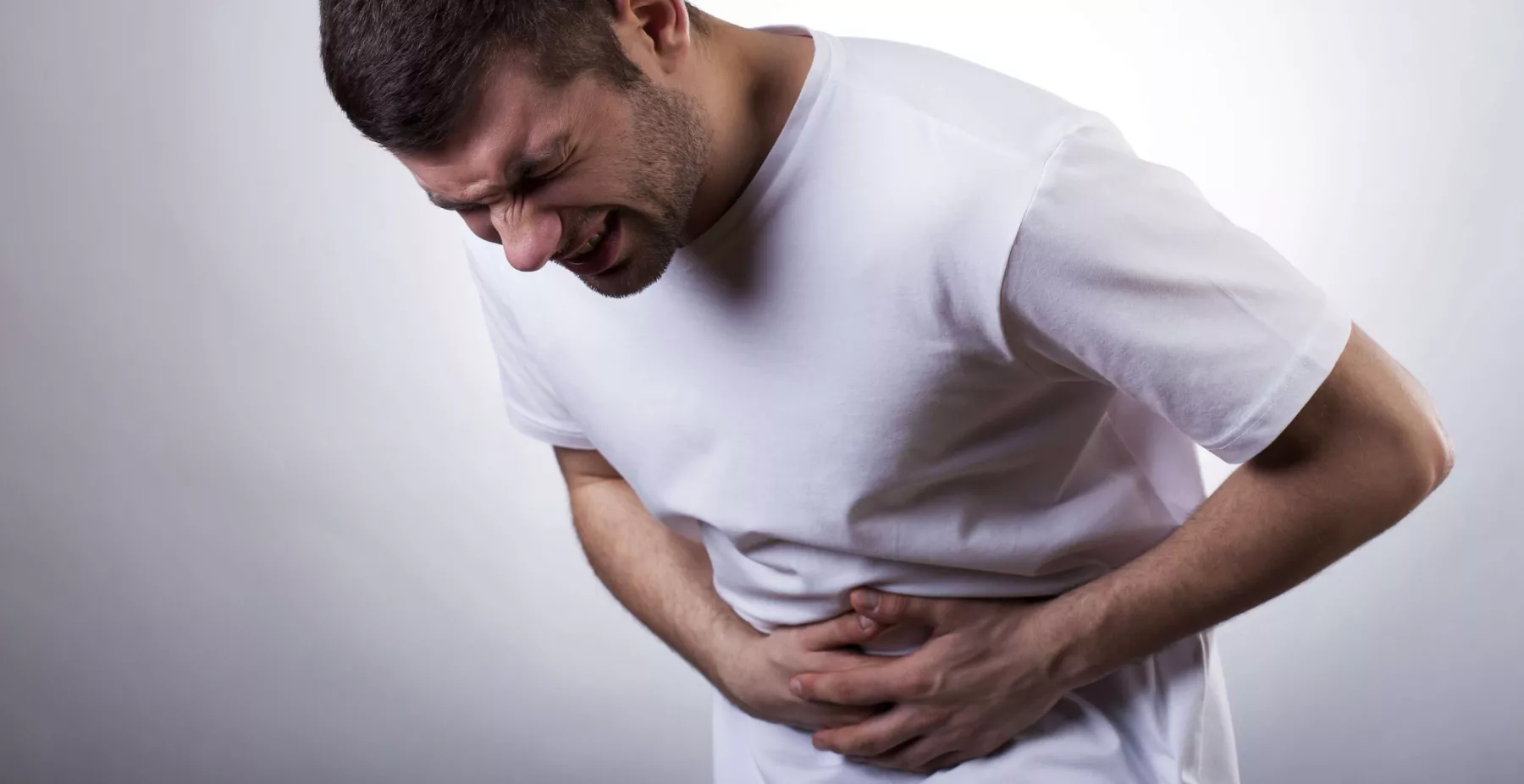 Estos son los síntomas del norovirus y qué es este virus. (Hombre con malestares en el estómago). 