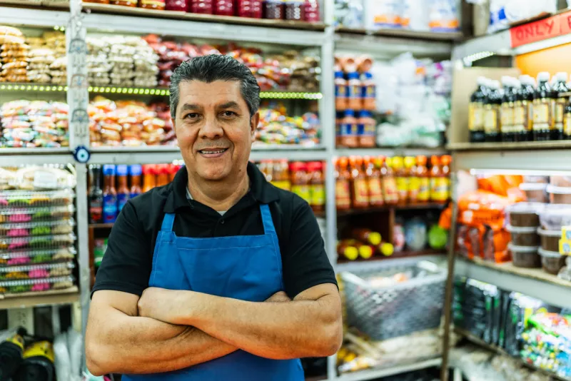 Portrait of a mature salesman working at market