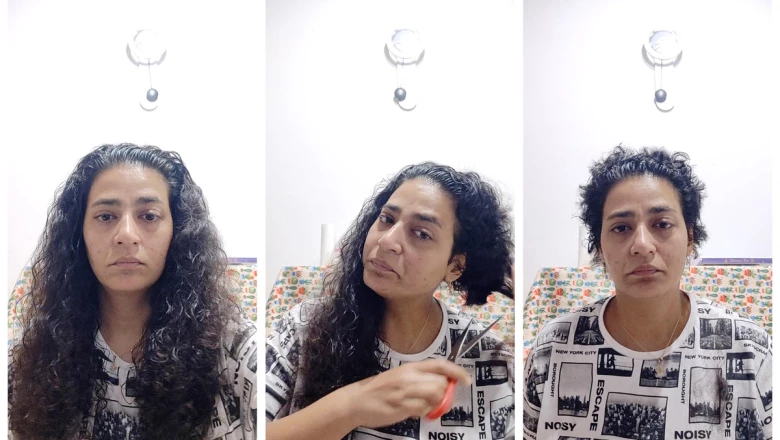 A woman cuts her hair in protest over death of Iranian woman Mahsa Amini in police custody, near Bologna