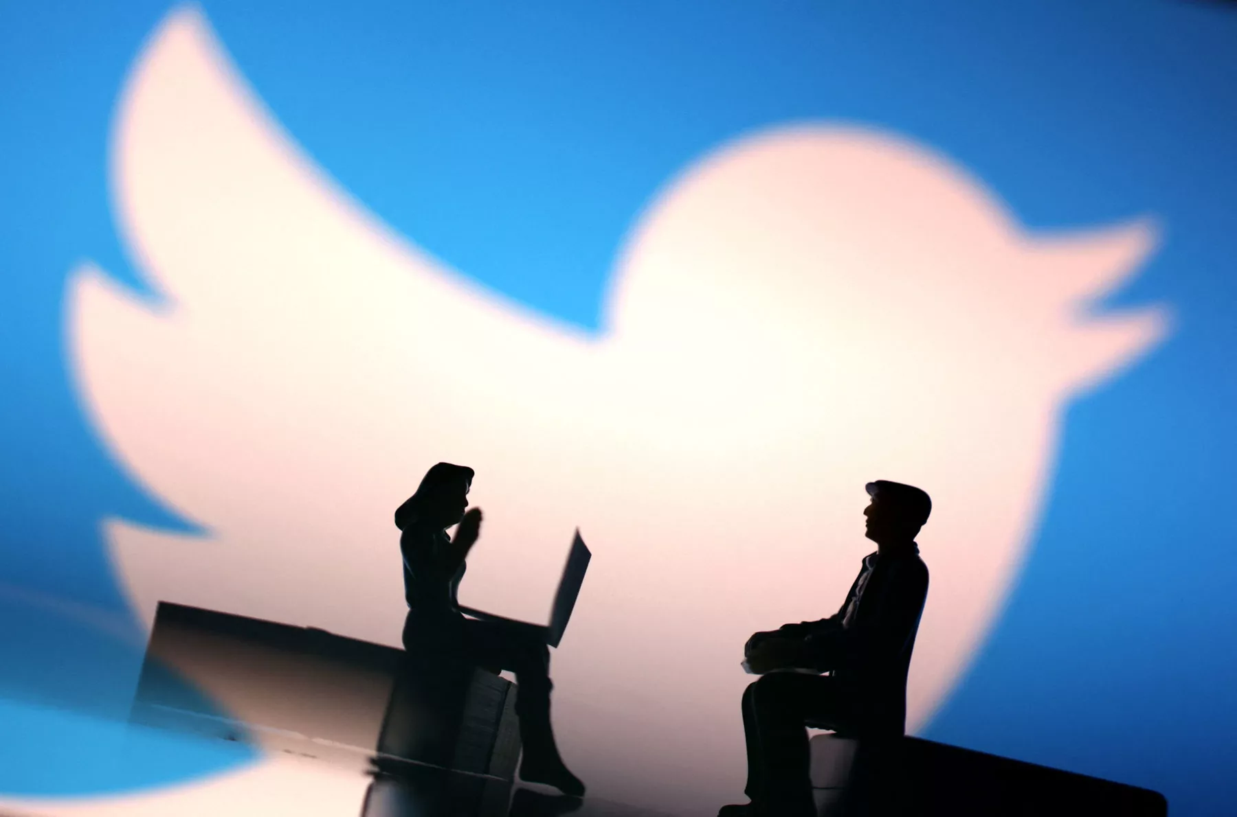 Illustration shows small figurines and Twitter logo