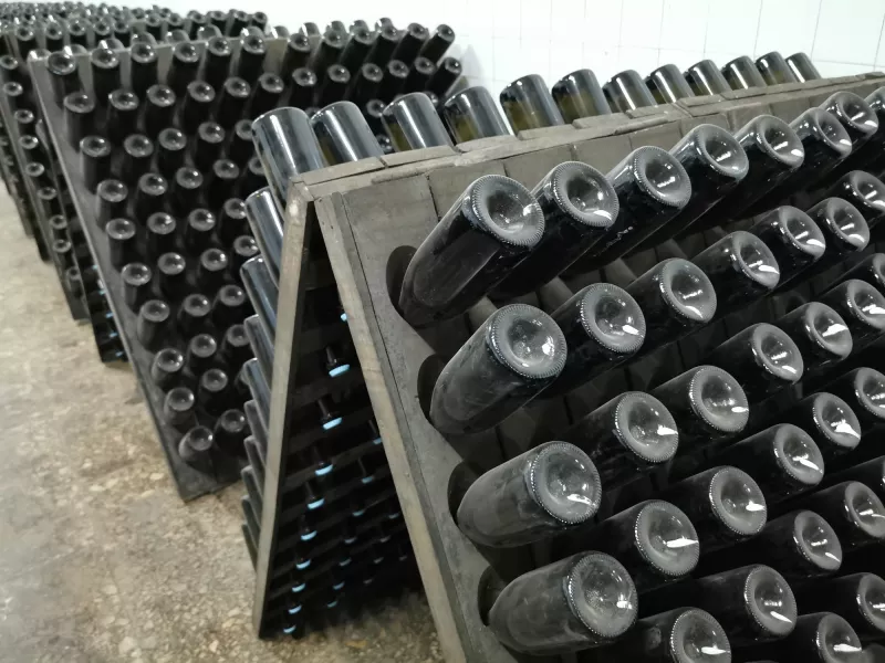 Champagne bottle production in winery cellar