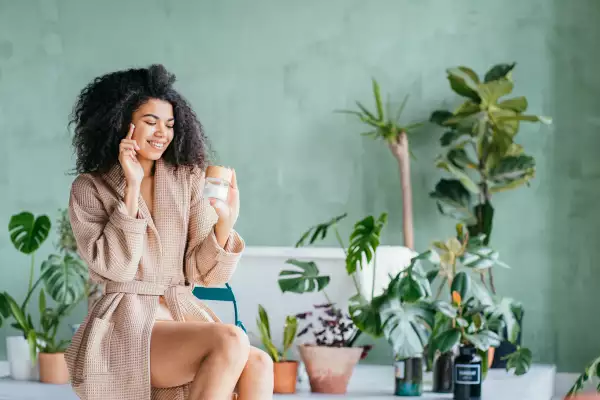 Funny,Smiling,Eco,Friendly,African,Young,Woman,In,Bathrobe,Apply