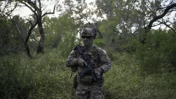 An agent with the U.S. Border Patrol Tactical Unit guards the U.S. side of the border with Mexico in Fronton, Texas