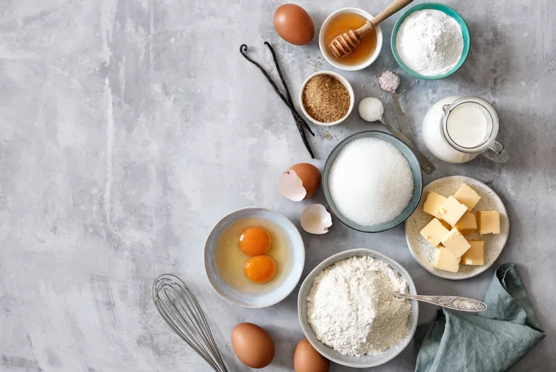 Baking ingredients: flour, eggs, sugar, butter, milk and spices