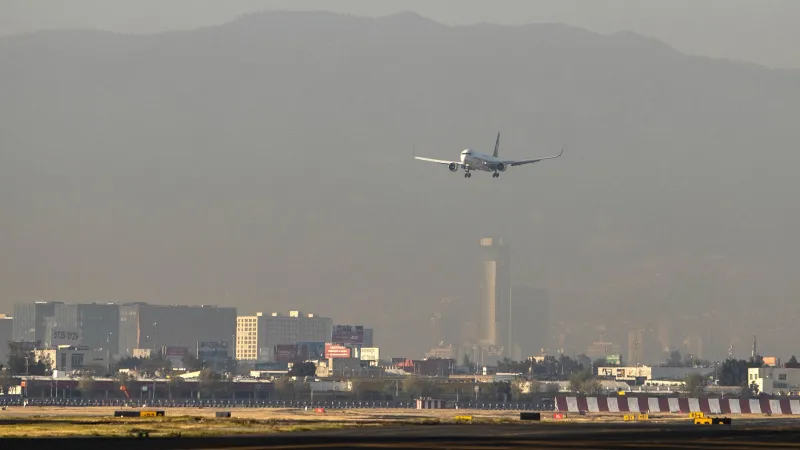 Un avión que desciende y está por aterrizan en el AICM. 