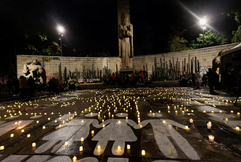 Family members and friends of missing persons participate in a candlelight vigil, in Mexico City