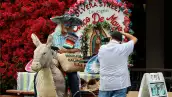 A un visitante se le toma una foto en la calle Olvera, una calle peatonal histórica y un mercado mexicano el 5 de mayo de 2025 en Los Ángeles, California.